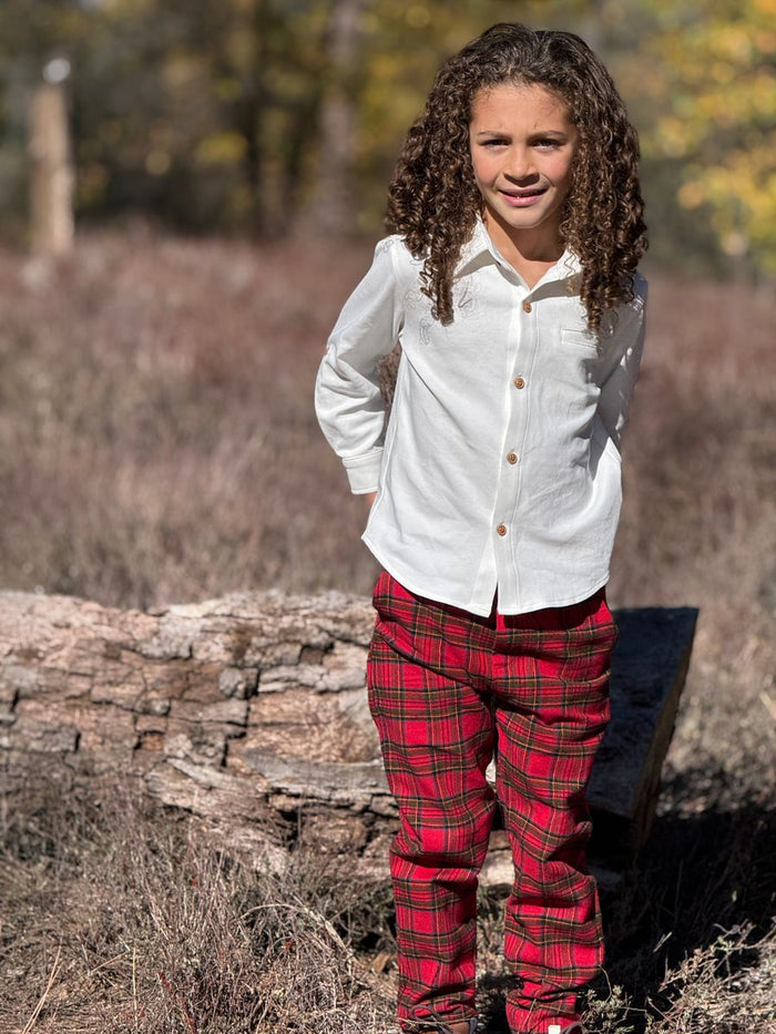 Child wearing red plaid pants