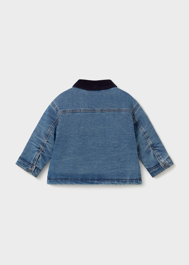 Blue denim jacket on a light gray background