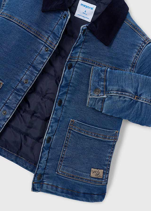 Blue denim jacket with quilted lining on a white background