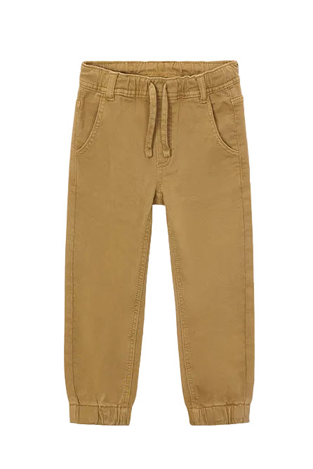 Tan jogger pants on a light beige background
