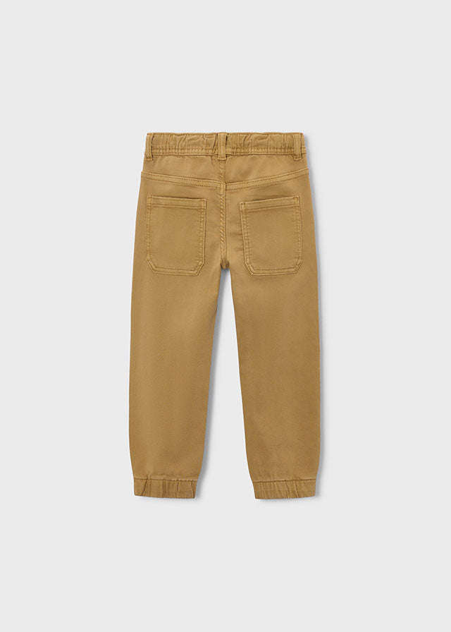 Tan pants on a light gray background
