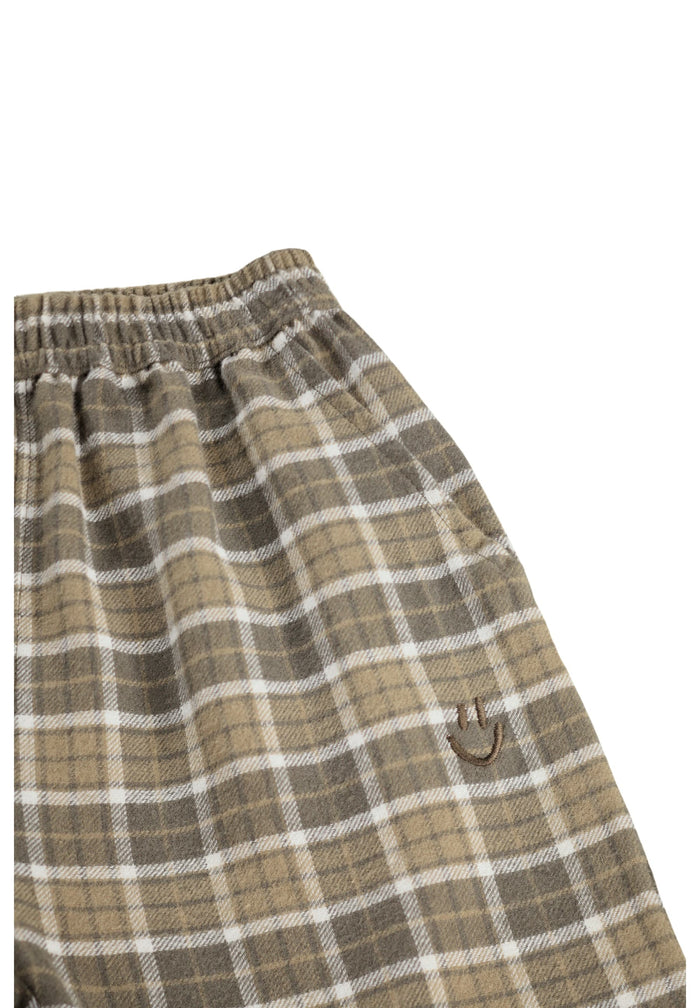 Plaid pants with a visible brand logo on a white background