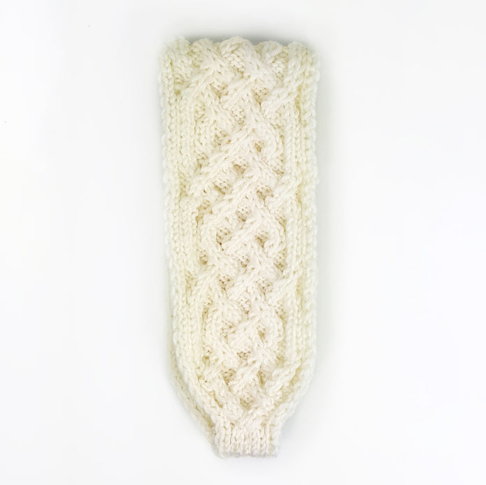 Cream cable-knit Sorcha headband laid flat showing interlocking Celtic cable pattern