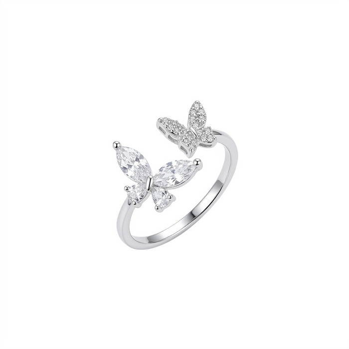 A silver adjustable open ring featuring two butterflies, one set with marquise-cut crystals and the other with small pavé stones, shown on a pure white background.