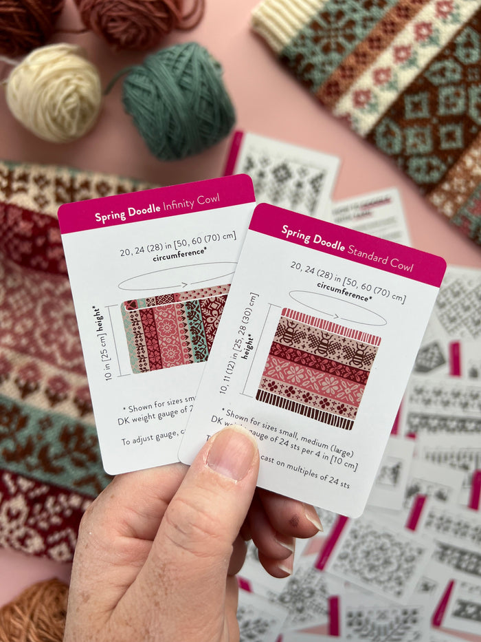 Hand holding the Spring Doodle Infinity Cowl and Standard Cowl schematic cards