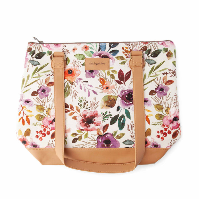 Top-down view of Spring Floral Mega Trinity Bag showing the full watercolor floral print pattern with tan faux leather bottom and shoulder straps