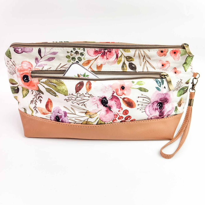 Back view of Spring Floral Trinity Bag showing the exterior zipper pocket partially open with the floral print pattern