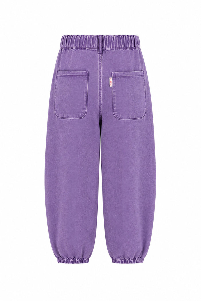 Purple denim pants with an elastic waistband and cuffed ankles, featuring two large back patch pockets, shown from the back on a white background.
