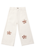 White pants with floral embellishments on a white background