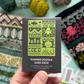 Hand holding the green and black Summer Doodle Card Deck by Pacific Knit Co tuckbox