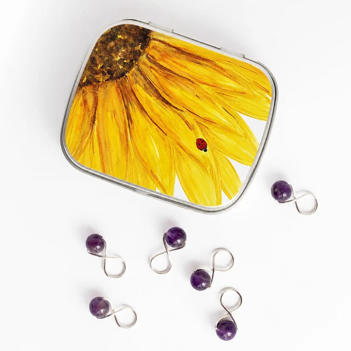 Small sunflower stitch marker tin with hinge lid and purple amethyst stitch markers