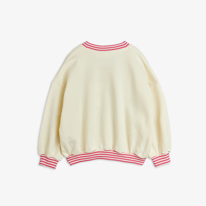 Cream-colored sweater with pink striped cuffs and neckline on a white background