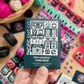 Hand holding the dark teal Tech Doodle Card Deck by Pacific Knit Co tuckbox