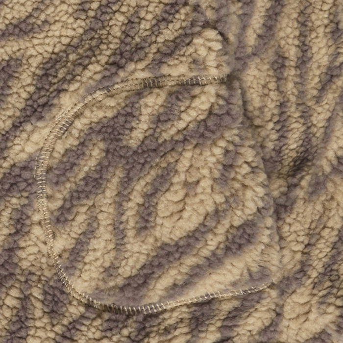 close up of brown and tan zebra stripe fleece with pocket.