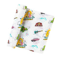 Rolled fabric with colorful guitars, cars, barns, mountains, and text on a white background