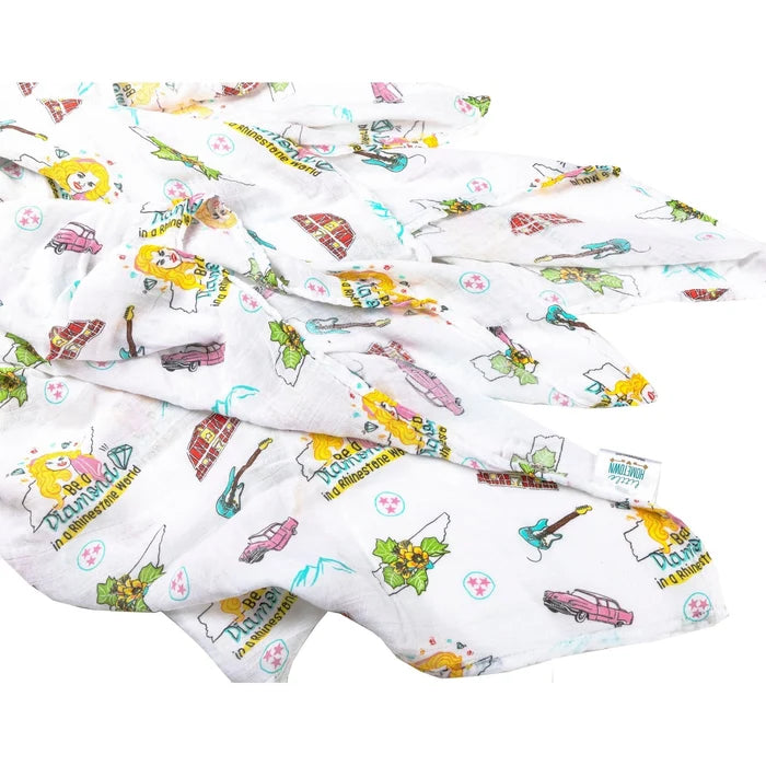 fabric with colorful guitars, cars, barns, mountains, and text on a white background