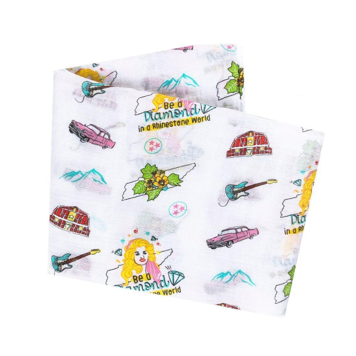 fabric with colorful guitars, cars, barns, mountains, and text on a white background