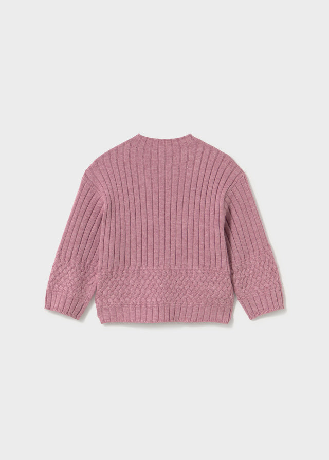 Pink knitted sweater on a light gray background