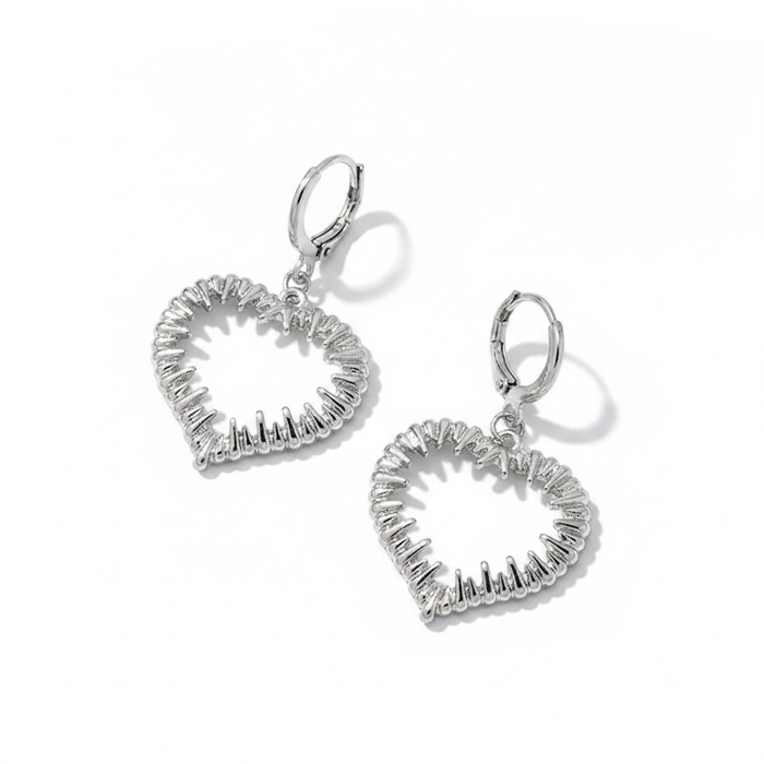 Silver heart-shaped drop earrings with textured design on a white background