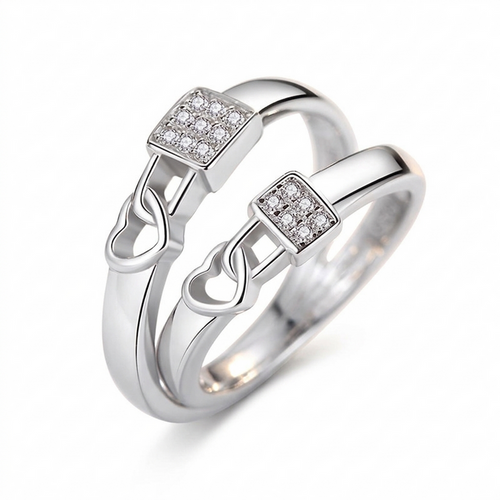 "Pair of silver heart-lock rings featuring a square centerpiece encrusted with shimmering crystals on a white background."