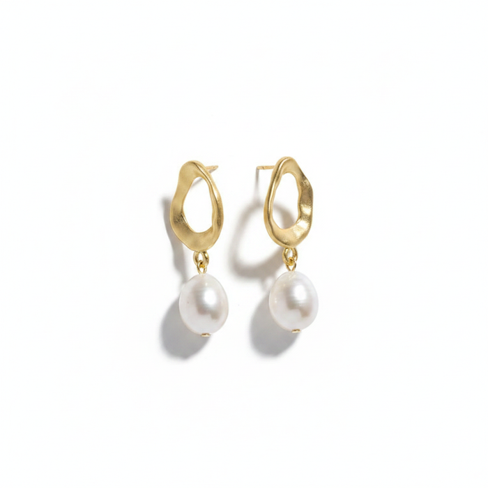 A pair of gold-toned drop earrings featuring an irregular, organic-shaped matte oval stud. Hanging from each stud is a large, teardrop-shaped white baroque pearl. The earrings are photographed on a clean white background with a soft shadow.