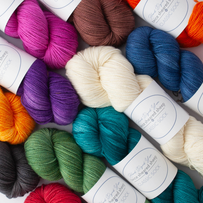 All TSS Classic Sock colorways arranged in rows showing the complete range of hand-dyed fingering weight yarn colors from warm earth tones to cool blues and purples with Twice Sheared Sheep labels