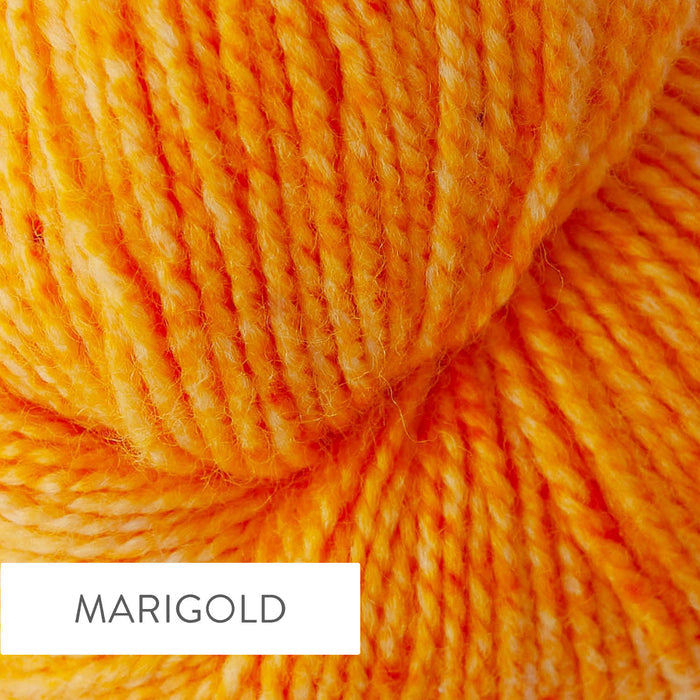 Close-up of TSS Classic Sock yarn in Marigold colorway showing the hand-dyed golden yellow and warm amber tones