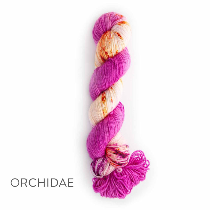 Single skein of TSS Classic Sock Paints yarn in Orchidae colorway featuring vivid magenta pink and fuchsia variegated hand-dyed sections