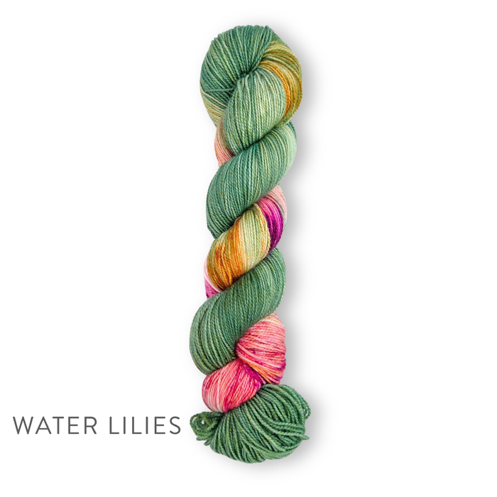 Single skein of TSS Classic Sock Paints yarn in Water Lilies colorway featuring sage and moss green sections with pink and golden yellow accents on a white background