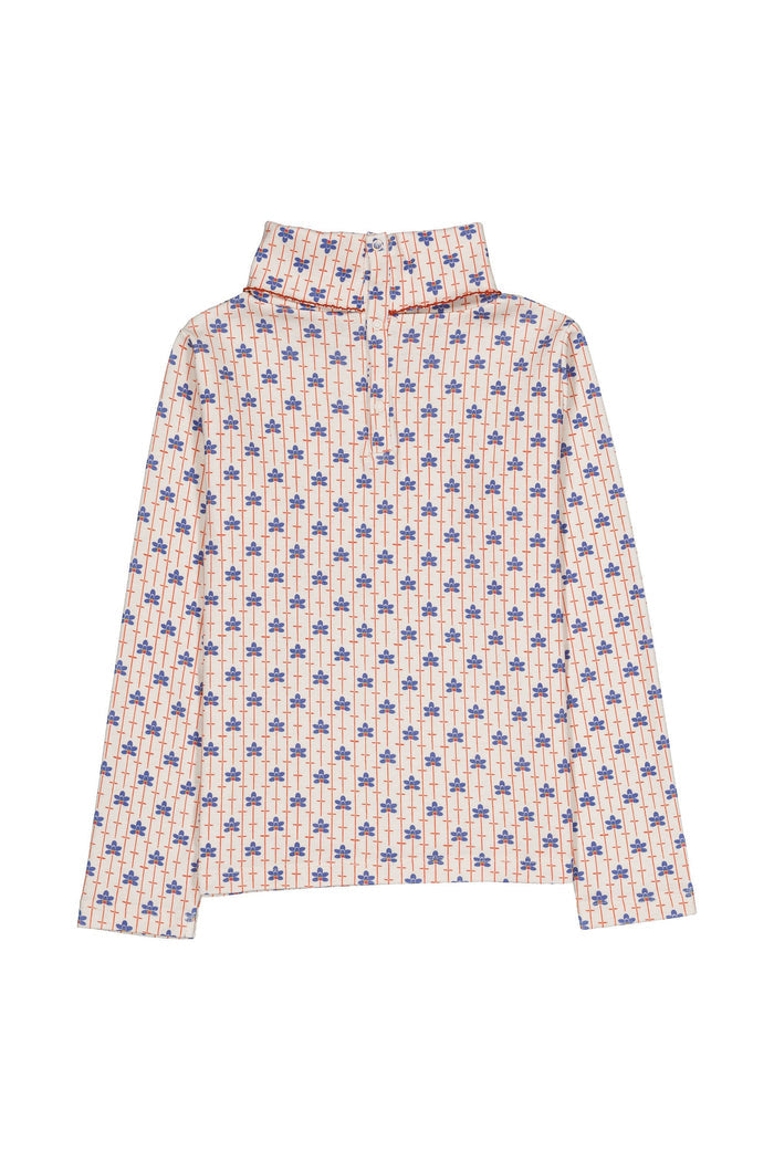 A long-sleeve high-neck shirt with a repeating blue and red floral pattern on a light beige background, displayed flat against a white background.