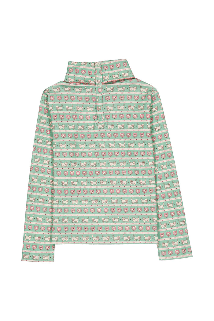 A long-sleeve mock turtleneck with a green, pink, and white kitten pattern, displayed flat against a white background.