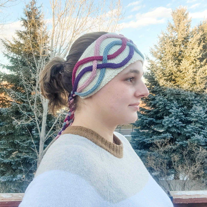 Model wearing the Twining Roads Headband in cream with colorful cord quill cables, side profile view showing the braided tie at the back
