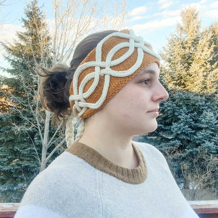 Model wearing the Twining Roads Headband in golden mustard with white cord quill cables, side profile view showing the full cable design