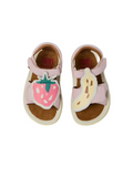 Pair of children's sandals with strawberry and banana designs on a white background