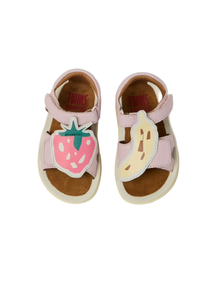 Pair of children's sandals with strawberry and banana designs on a white background