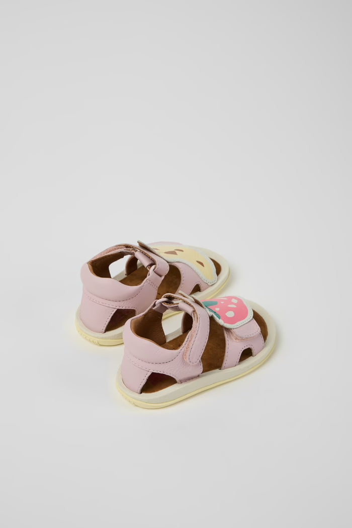 Pair of pink children's sandals with a white background