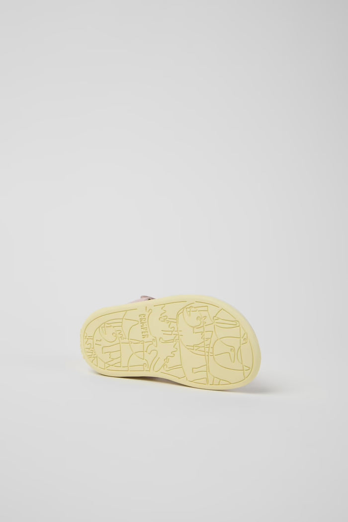 Yellow sneaker sole with brand logo on a light gray background