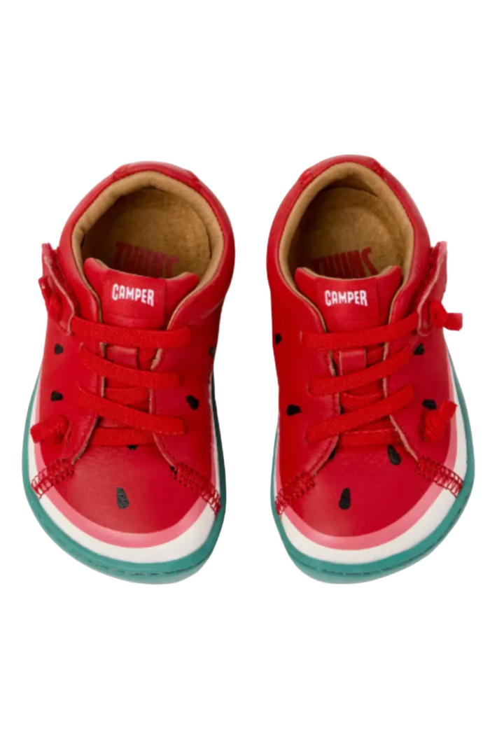 Red children's sneakers with watermelon design on a white background