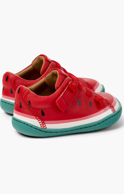 Red children's shoes with watermelon design on a white background