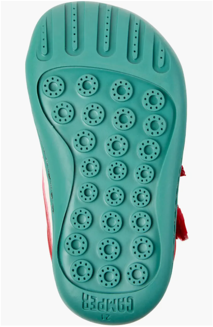 Teal sneaker sole with textured pattern on a white background