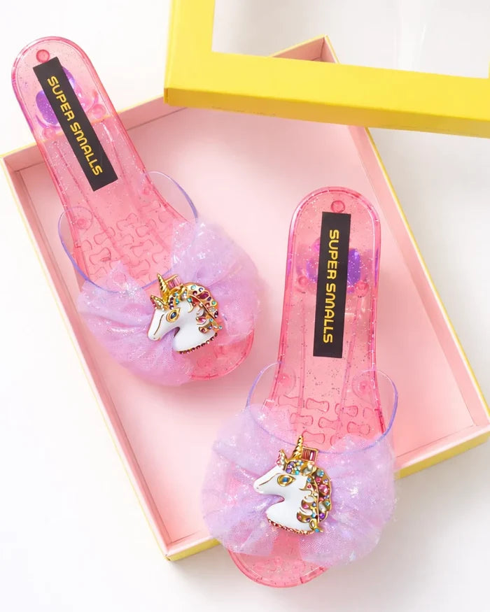 Pink shoes with unicorn charms in a box