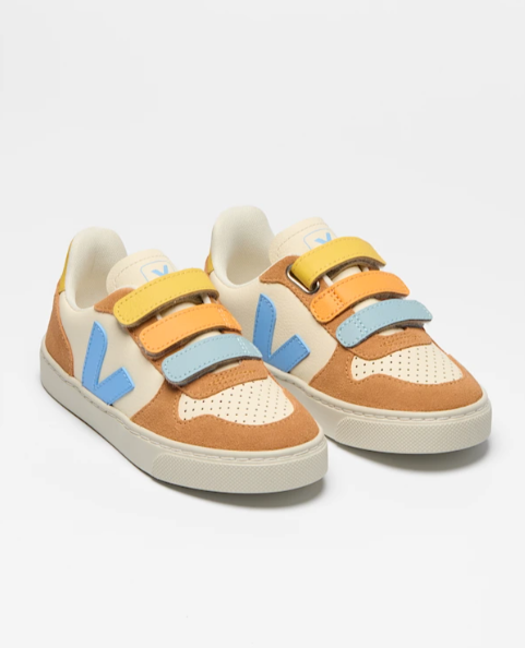 Pair of children's sneakers with colorful straps on a light gray background