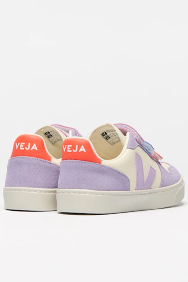 Pair of purple and pink Veja sneakers on a white background