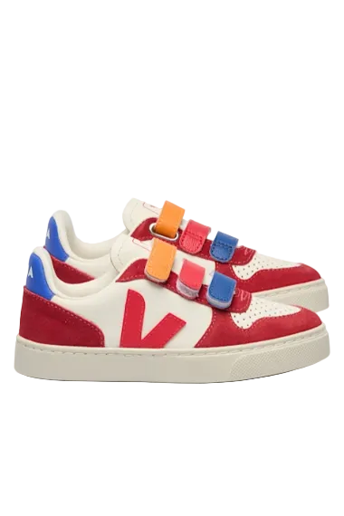 Red sneakers with colorful velcro straps on a light gray background