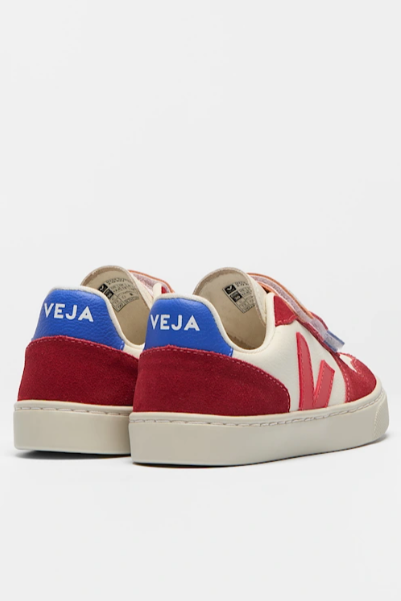 Red and blue sneakers with 'Veja' branding on a white background