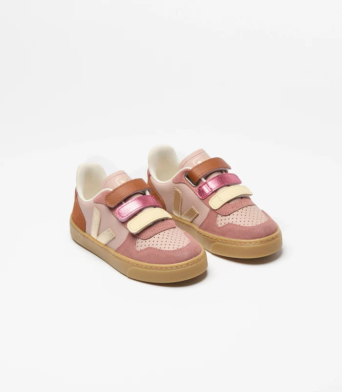 Pair of pink children's sneakers with brown soles on a white background
