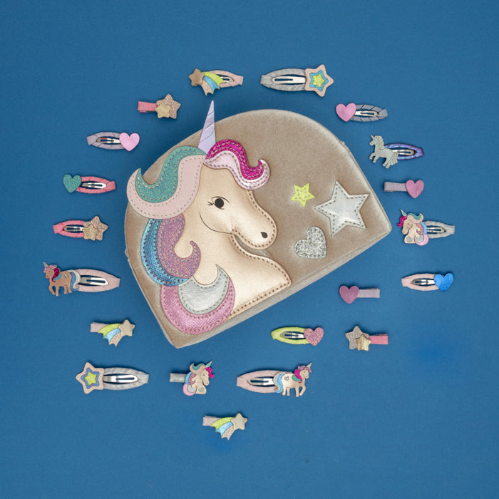 Unicorn-themed hair accessories on a blue background