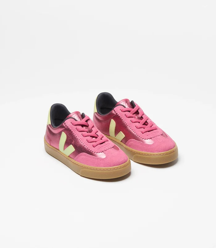 A pair of Veja sneakers in pink suede and leather, featuring yellow green side V, pink elastic laces, and gum soles, photographed on a clean white background.