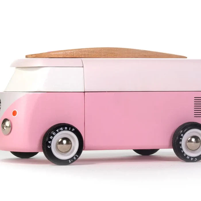 Pink toy van with wooden top on a white background