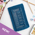 Blue knitted gauge swatch with a clear gauge ruler on a white background